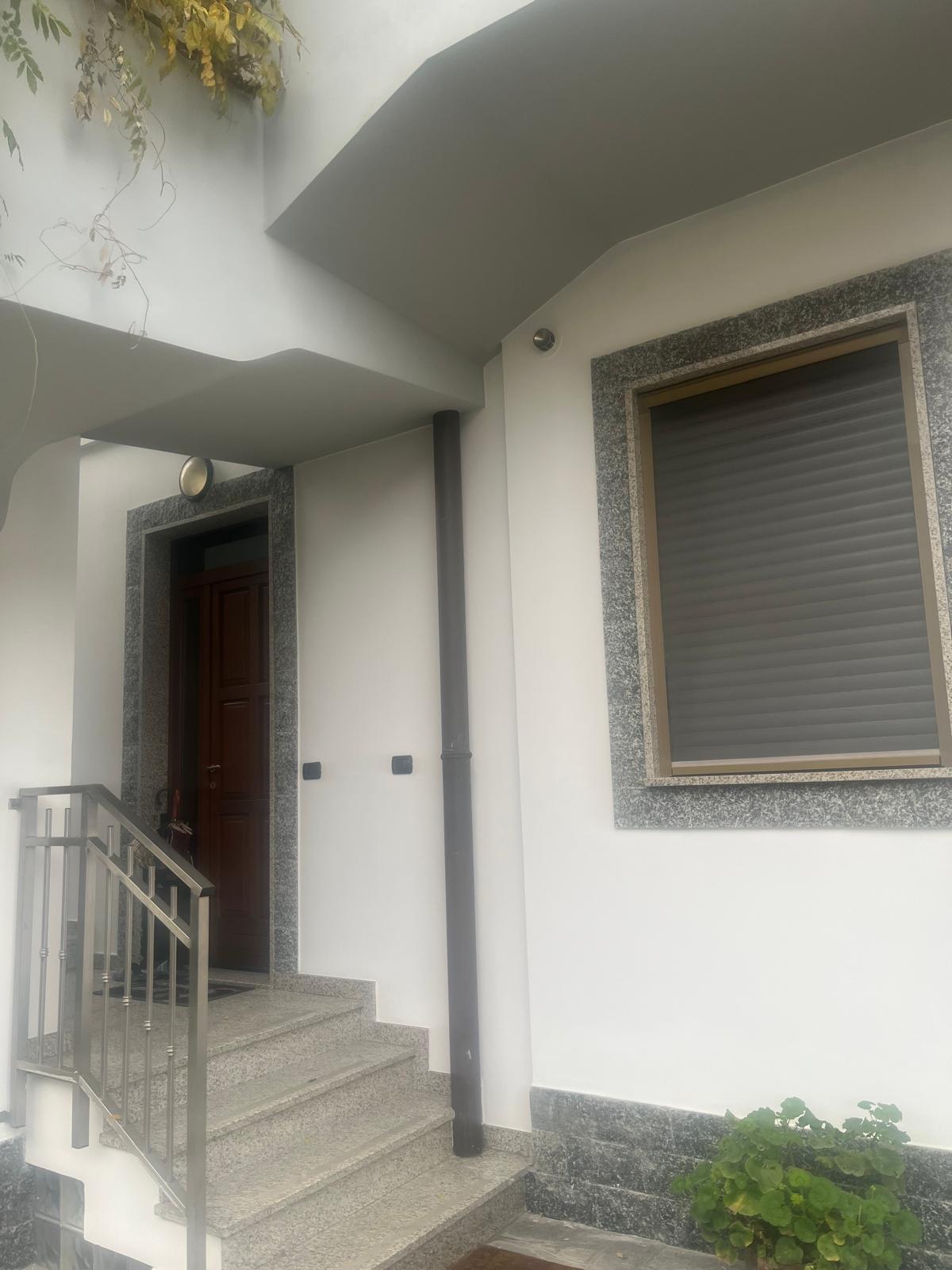 Ingresso villetta con facciata tinteggiata e cornici in granito
